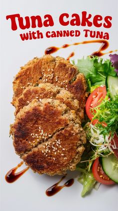 tuna cakes with canned tuna on a white plate next to a salad and dressing