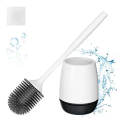 a brush and cup with water splashing on the surface next to it's holder