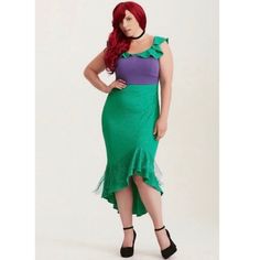 a woman with red hair wearing a green and purple dress