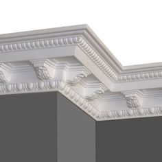 the corner of a white ceiling with decorative molding on it's sides and top