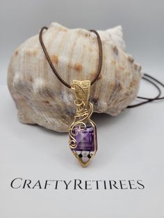 Discover the elegance of this stunning emerald-cut synthetic bi-color Amethyst pendant, skillfully wire-wrapped in luxurious yellow gold-filled wire. The pendant showcases the captivating gradient of purple and lavender hues, complemented by the brilliance of Herkimer Diamond and the deep tones of Obsidian accent stones. This unique piece combines the vibrant beauty of synthetic gemstones with the warm sophistication of gold, making it an exquisite addition to any jewelry collection. Design Features: The emerald cut highlights the bi-color Amethyst's beautiful transition from deep purple to soft lavender. Accented by sparkling Herkimer Diamond and the grounding presence of Obsidian, this pendant is elegantly wrapped in yellow gold-filled wire, adding a touch of luxury. Perfect for: Special Elegant Purple Wire Wrapped Jewelry, Sophisticated Jewelry, Soft Lavender, Obsidian Stone, Lab Created Emerald, Collection Design, Polymer Clay Projects, Amethyst Pendant, Herkimer Diamond