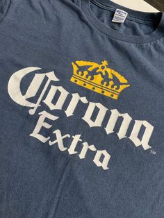 Vintage Corona Extra T Shirt Size Medium See pics for measurements Heather Blue Color Some cracking of Logo. Perfect patina See our other Corona items here on Etsy Fast shipping. We ship same or next day with USPS We are a small family business and we appreciate your business, Godspeed ! Pre-shrunk Blue Crew T-shirt, Blue Crew Neck Screen Print Top, Blue Crew Neck Top With Screen Print, Blue Graphic Print Crew Top, Blue Letter Print Crew Neck Tops, Blue Crew Neck Top With Letter Print, Blue Crew Neck Top With Graphic Print, Blue Pre-shrunk Crew T-shirt, Vintage Blue Tops With Letter Print