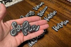 someone is holding out their name magnets to spell out the word, soffaa