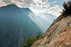 a person standing on top of a cliff