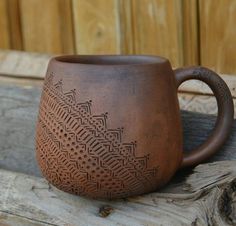 a brown mug sitting on top of a wooden table