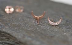 Here is a pair of modern diamond crescent moon studs. I decided to make a pair due to the high demand of my limited antique conversion ones. This pair is in 14k rose gold with pavé set diamond. They include 14k rose gold friction backs. Diamonds Cut: Round Brilliant Cuts Color: G-H Clarity: SI2-I1 Weight: 18 = 0.10 cts Measurements: 1.3 - 0.8 mm Dimensions: 9.6 x 6.4 mm Metal: 14k rose gold Markings: PD and makers mark on one stud Circa: Made to Order Condition Rating: 10 Thanks for looking Rose Gold Crescent Earrings, Rose Gold Diamond Earrings, Moon Studs, Gold Diamond Earrings, Diamond Stud Earrings, Diamond Stud, Rose Gold Diamonds, Art Deco Style, Diamond Earrings Studs