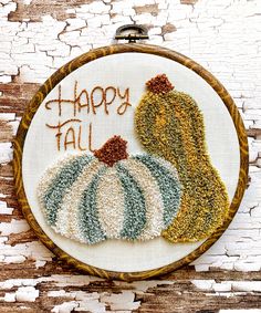 a embroidery kit with two pumpkins and the words happy fall