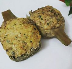 two cooked stuffed mushrooms on a white plate