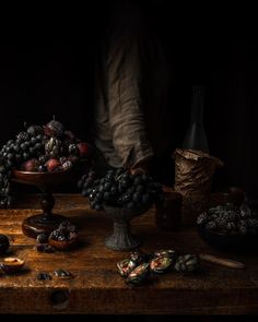 a table topped with lots of different types of fruit on top of a wooden table