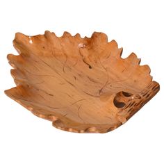 a wooden bowl that is shaped like a leaf