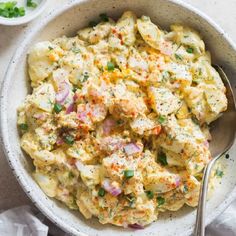 a white bowl filled with pasta and vegetables