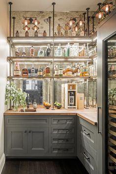 a kitchen filled with lots of counter top space next to a wall mounted wine rack