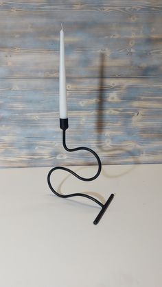 a black and white candle holder on a table