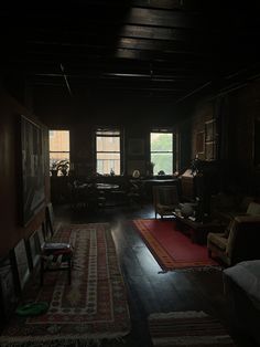 the dark room is filled with furniture and rugs