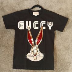 Authentic Gucci Bugs Bunny Shirt, Top, Blouse, T-Shirt. Size Xxs Colors: Black White, Hot Pink Sequins. Shirt Is In Great Condition. Pit To Pit: 16 Inches Top To Bottom: 23 1/2 Sleeve: 7 Inches This Shirt Would Fit Xxs To S Gucci Black Tops For Spring, Gucci Black Top For Spring, Gucci Graphic Print Top For Spring, Trendy White Gucci Tops, Black Gucci Tops With Letter Print, Spring Luxury Gucci Tops, White Fitted Gucci Tops, Gucci Black Short Sleeve Tops, Gucci White Fitted Tops