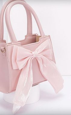 A blush pink purse with handles and strap, faux leather. with a pink ribbon bow attached design. Pink Purses, Girly Items, Disney Challenge, Purse Pink, Cute Lazy Day Outfits, Pink Handbags, Lazy Day Outfits, Pink Purse, Thanksgiving Outfit