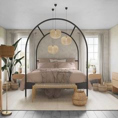 a bedroom with an iron bed frame and beige linens on the pillows, along with other furniture