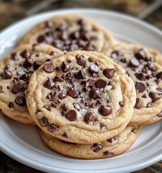 three chocolate chip cookies on a white plate