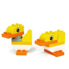 two yellow lego ducks sitting next to each other