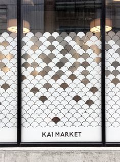 the front window of a store that has fish scales on it