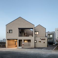 the house is made out of bricks and has two garages on each side, with one door open to let in light