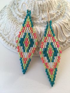 Handwoven diamond shaped beaded earrings made with Japanese delica glass beads. The ear wires are gold plated. Each earring is carefully handwoven by me with a needle and thread. If you like these earrings, but would like to change a color or colors, please contact me about custom orders. Care: When you are not wearing your earrings, I recommend that you hang them up or lay them down flat. Multicolor Drop Earrings With Spacer Beads, Multicolor Teardrop Jewelry With Spacer Beads, Gold Statement Jewelry, Woven Earrings, Jewelry Boho, Diamond Shaped, Bead Weaving, Teal Green, Boho Earrings