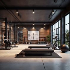 an empty gym with exercise equipment and yoga mats in front of large windowed windows