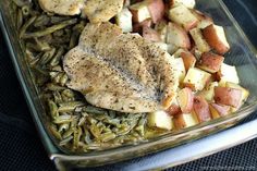 chicken and potatoes in a casserole dish with seasoning