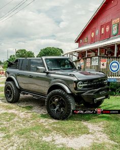 a truck parked in front of a red building