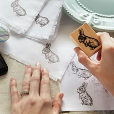 a person is stamping some animal designs on paper