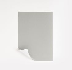 the corner of a piece of white paper with a curved edge is shown in this image