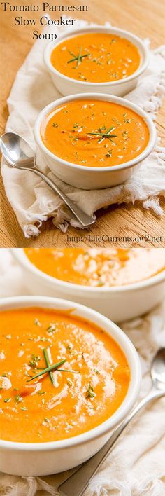 three bowls of carrot soup on a wooden table with silver spoons and white napkin