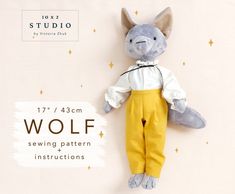 a stuffed animal that is wearing yellow pants and a white shirt with the words wolf on it