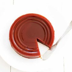 a piece of chocolate cake on a white plate with a bite taken out of it