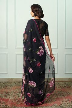 Black french chiffon saree with floral print and satin piping. Comes with an organza embroidered unstitched blouse piece.
Components: 2
Pattern: Printed, Embroidered
Type Of Work: Floral
Fabric: Saree : French chiffon, Blouse Piece : Organza
Color: Black
Other Details: 
Length :
Saree : 5.5 mtrs
Unstitched Blouse : 1 mtr
Note : Stitched blouse worn by the model is not for sale.
Occasion: Wedding - Aza Fashions Floral Saree Blouse, Floral Saree, Black French, Chiffon Saree, Printed Sarees, Chiffon Blouse, Blouse Piece, Floral Fabric, Saree Blouse