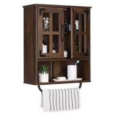 a wooden cabinet with glass doors and towel rack on the front, holding toiletries