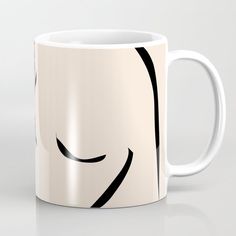 a white coffee mug with black lines on the front and back of it's face