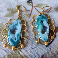 This Listing Is For A Pair Of Stone/Quartz Druzy Earrings. The Difference Between A Geode And Druzy Is The Geode Is The Entire Stone, Including Druzy, While Druzy Only Refers To The Layer Of Crystals. The Druzy Is Transparent, Showing The Marbling Of The Teal And The White/Clear Design. The Earrings Measure Approximately 1 1/2", Not Including The Ear Wire. The Druzy Stone Is Surrounded By A Gold Tone Metal, Loop Design. They Are Brand New, Never Worn, Perfect For Gift Giving. It Will Arrive In A Loop Design, Druzy Earrings, Druzy Quartz, Marbling, Pierced Earrings, Quartz Stone, Ear Wire, Gold Tone Metal, Gift Giving