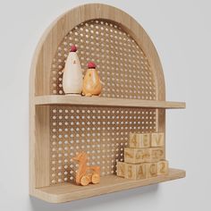 two wooden shelves with toys on them against a gray background, one shelf is made out of perforated wood