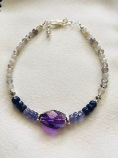 "Beautiful shades of purple and blue with glittery faceted  Labradorite.  The gems are genuine and gorgeous.  All strung on quality jewelry wire for strength and longevity.  The size is adjustable from 7-1/2\" to 8\", if you need a different size please contact me." Spiritual Sterling Silver Gemstone Bracelet For Healing, Spiritual Purple Sterling Silver Bracelet, Silver Amethyst Bracelets With Faceted Beads, Blue Amethyst Bracelets With Natural Stones, Blue Amethyst Hand-strung Jewelry, Purple Faceted Spiritual Bracelets, Spiritual Purple Faceted Bracelets, Healing Amethyst Bracelets With Faceted Beads, Spiritual Faceted Purple Bracelets