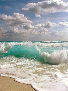 an instagram photo of the ocean with clouds in the sky and waves crashing on the beach