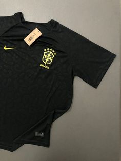 the nike soccer jersey is on display in front of a gray wall with a tag attached to it