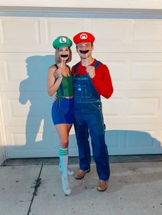 two people dressed up as mario and luigi in front of a garage door