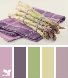 some asparagus are sitting on top of purple napkins and the color is green