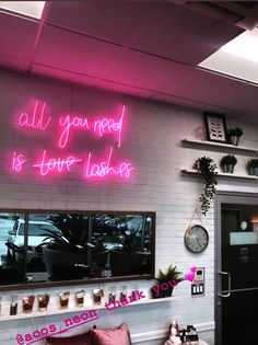 a pink neon sign that says all you need is to be taken home on the wall