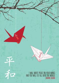 two red origami birds hanging from a tree branch with chinese characters on it