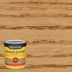 a can of wood finish sitting on top of a wooden floor