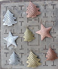 six metal christmas trees on a grate with polka dotty dots and twine