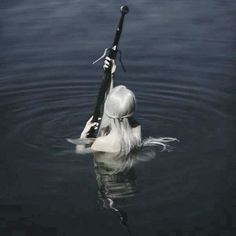 a woman is in the water with a fishing pole