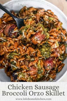 chicken sausage broccoli orzo skillet in a white bowl with a spoon